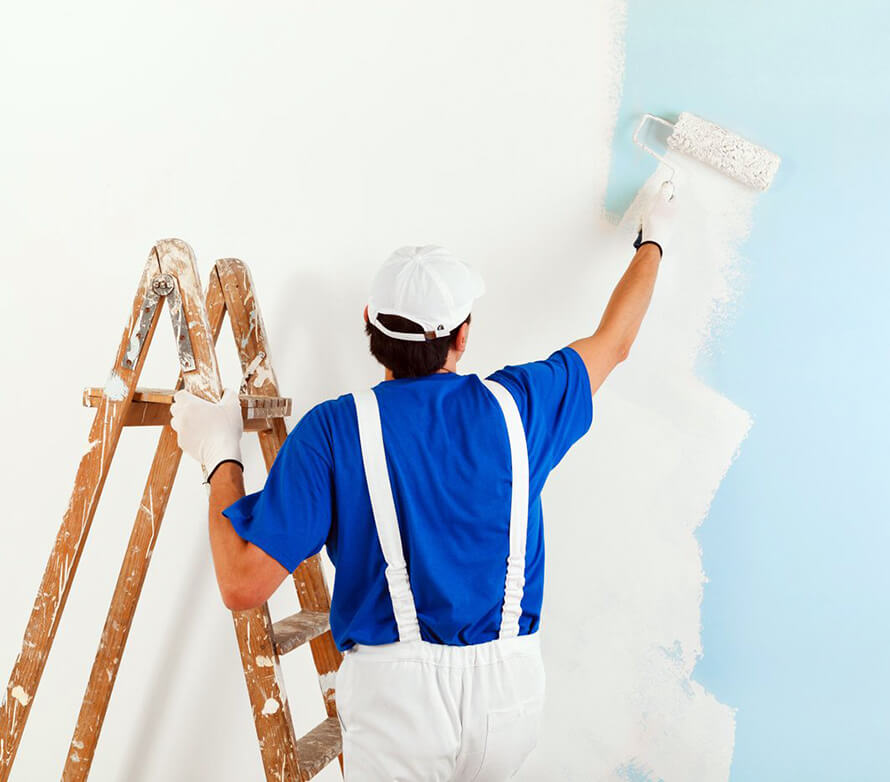A person painting the wall.