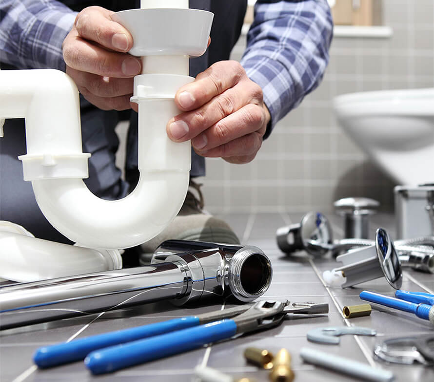 A person fixing a plumbing issue.